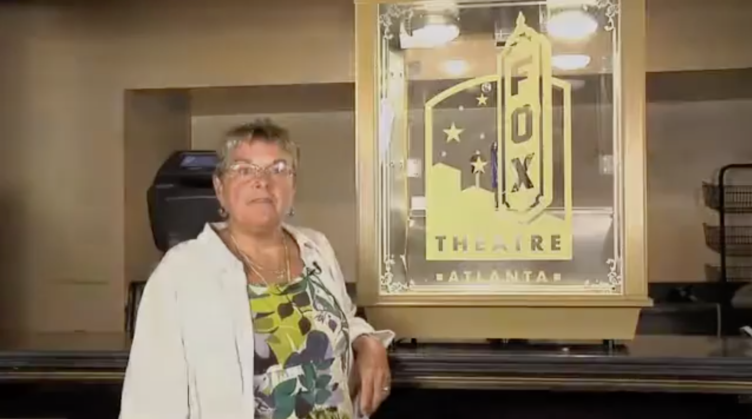 woman in front of popcorn machine
